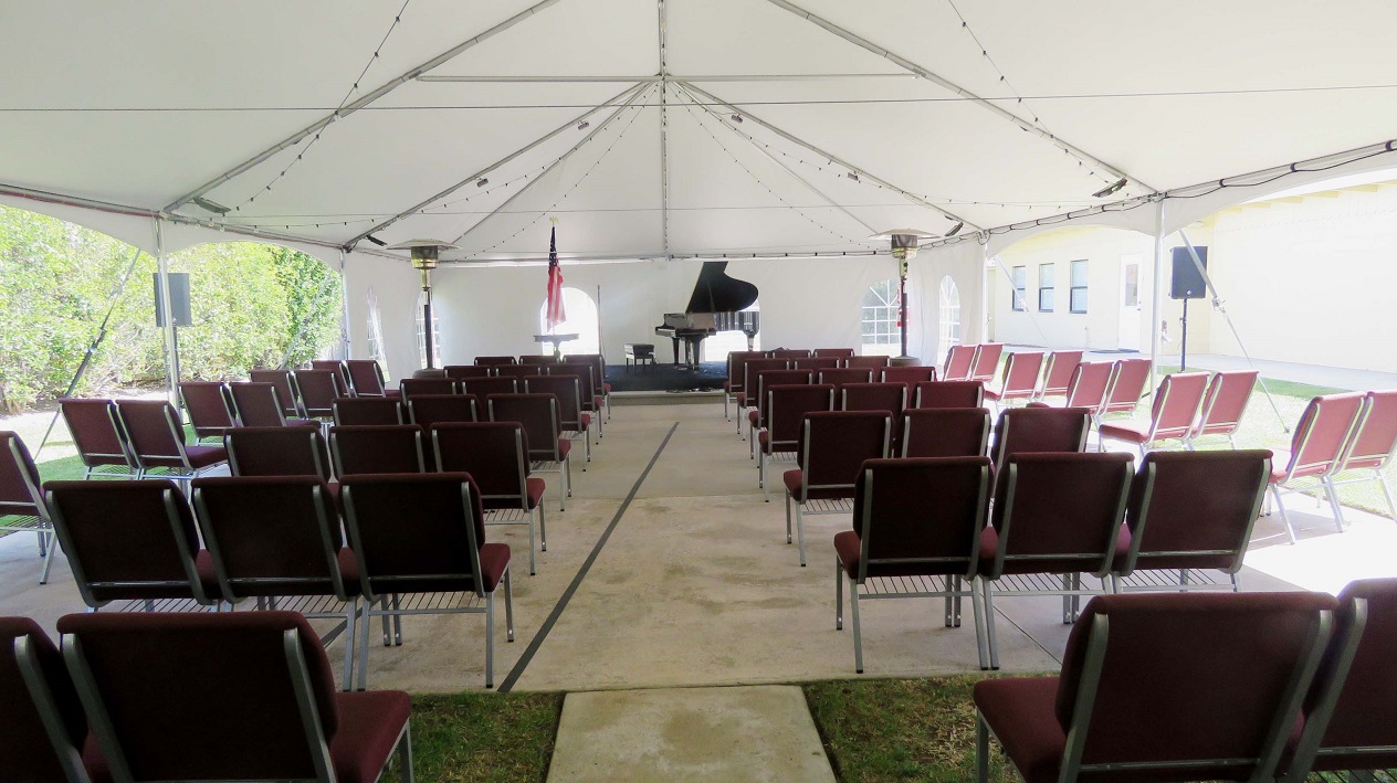 The concert stage is set in the tent